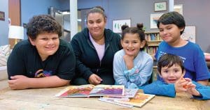 Jennifer, who recently become employed as a caregiver, with her kids, ages 6, 7, 10 and 12.