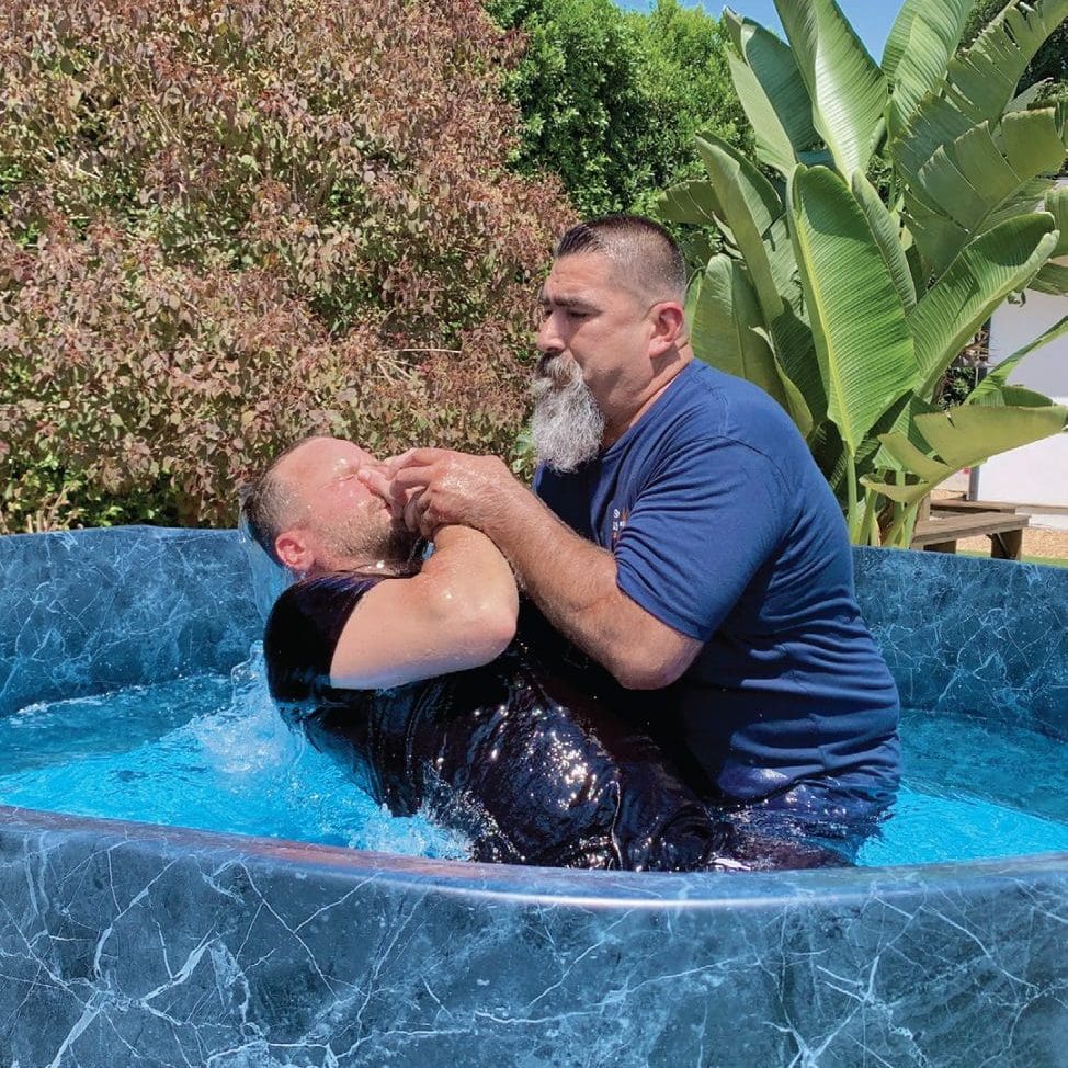 Program Manager Oscar Corral (right) was “blessed” to baptize the men.